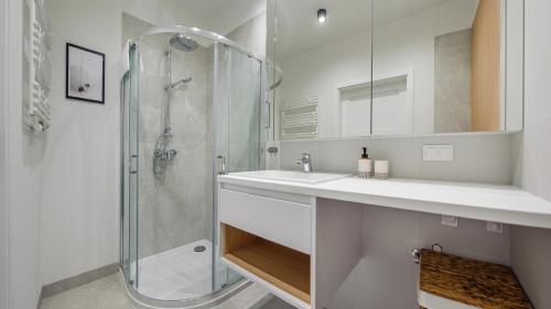 a bathroom with a sink and a shower at Nexo, Sun & Snow in Puck