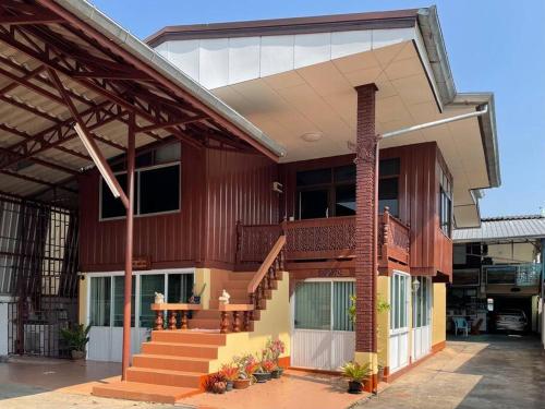 a building with a staircase in front of it at Tintin home in Chiang Rai