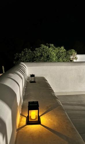 a light sitting on the side of a wall at night at Dimora delle Tonnare in Favignana