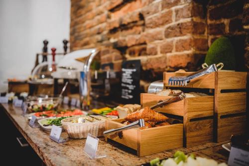 a buffet of food on a counter in a store at Hotel Solaris in Toruń