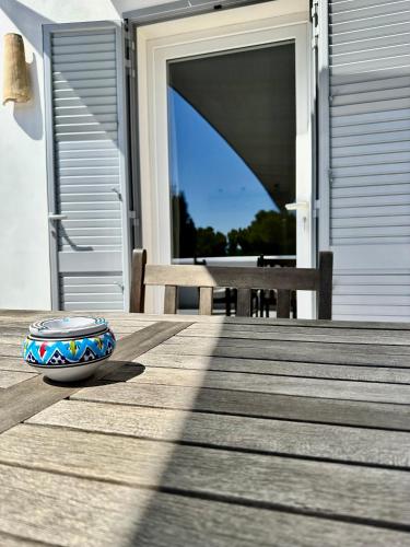 a dog bowl sitting on a wooden deck at Dimora delle Tonnare in Favignana