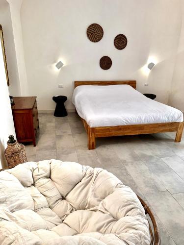 a bedroom with two beds and a couch in it at Dimora delle Tonnare in Favignana