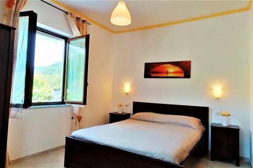 una camera con un letto e una grande finestra di Amalfi Coast Countryside with Jacuzzi and Garden a Polvica