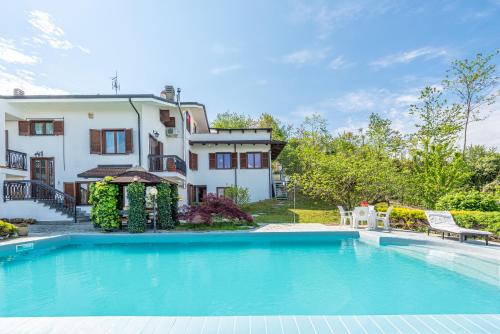 a large swimming pool in front of a house at Alba View Apartments with Pool in Alba