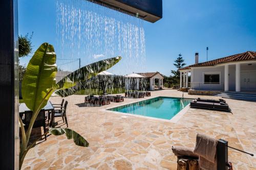 a swimming pool with a fountain in a house at Villa Ellania in Ambelókipoi