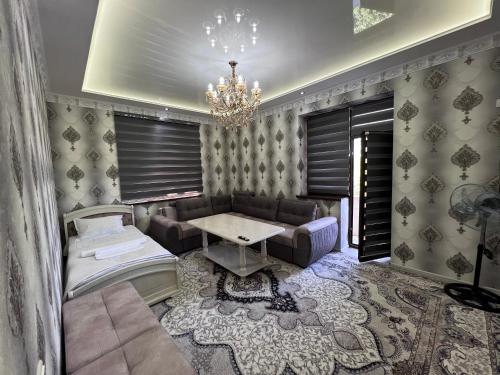 a living room with a couch and a table at COMFORT iNN 2 in Samarkand
