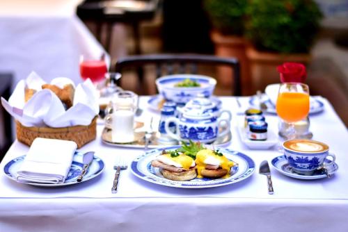 a table with plates of food and drinks on it at Rachamankha Hotel in Chiang Mai