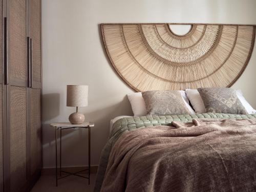 a bedroom with a bed with a large circular mirror at Conte Gesto Villa, with Heated Pool, By ThinkVilla in Akrotiri