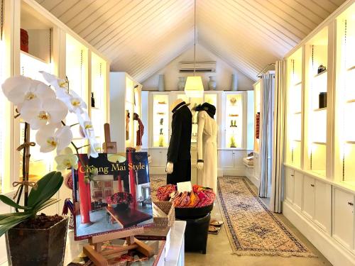 a store with two people standing in a hallway at Rachamankha Hotel in Chiang Mai