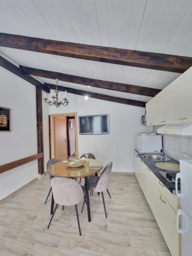 a kitchen and dining room with a table and chairs at Luxury Apartments Silva with sea view in Trogir