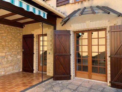 a pair of doors on a house at Lovely House in Quiet Hamlet on banks of the Lot in Saint-Martin-Labouval