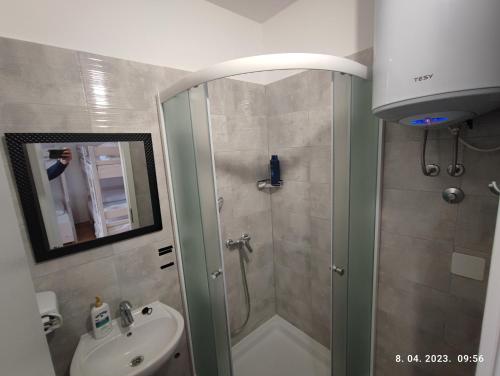 a bathroom with a shower and a sink at Impact House Split in Split