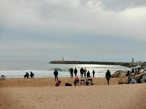 a group of people standing on a beach at PENICHE - Guest House Casa das Estelas in Peniche