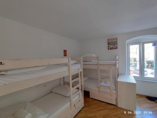 a room with two bunk beds and a window at Impact House Split in Split