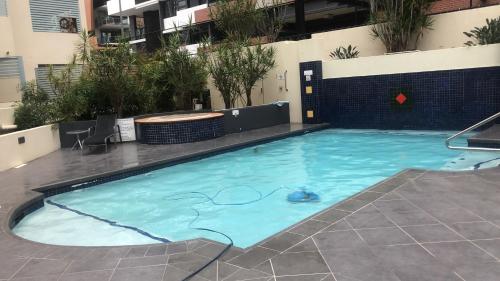 a large swimming pool in the middle of a building at Beautiful rooms in An Apartment Free Parking in Brisbane