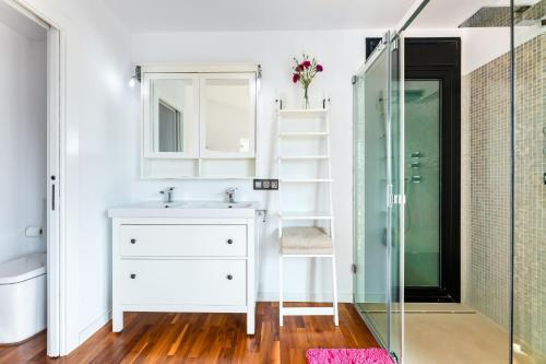 a bathroom with a sink and a glass shower at Villa La Primera in Llucmajor