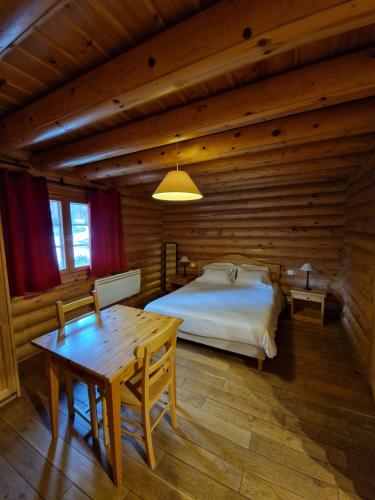 a bedroom with a bed in a log cabin at Appart Hôtel Le Pin Sylvestre in Amnéville