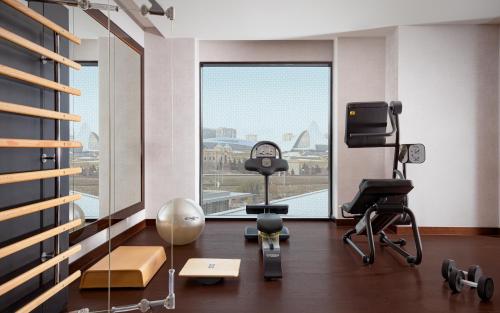 a room with a gym with a view of the city at The Ritz-Carlton, Baku in Baku