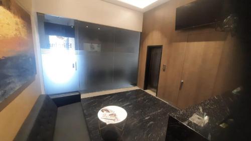 a bathroom with a black counter top and a mirror at Elite Inn, Kolhapur, 100 Mts from Railway Station in Kolhapur