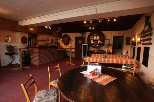 a dining room with a wooden table and chairs at Weingut Pension Gibbert-Pohl in Briedel