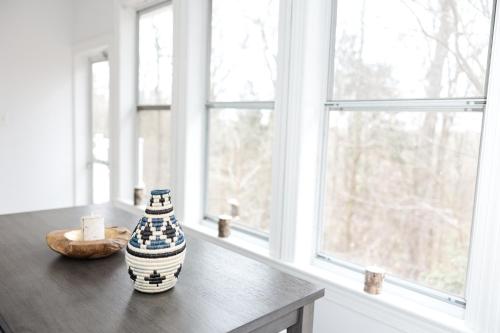 a vase sitting on a table in front of a window at Cowry Acres - 11 Acre Enchanted Retreat, Hot Tub in New Hope