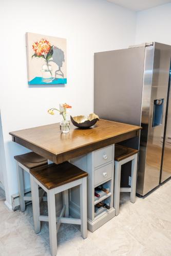 a kitchen with a table and a refrigerator at Cowry Acres - 11 Acre Enchanted Retreat, Hot Tub in New Hope