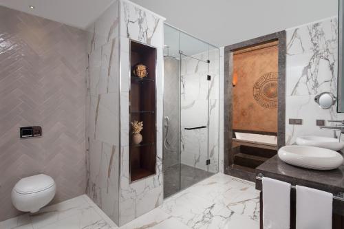 a bathroom with a shower and a toilet and a sink at Lionel Hotel Istanbul in Istanbul