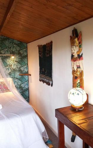 a bedroom with a bed and a table and a painting at Casa do Sobreiro 2 in Serra das Alhadas