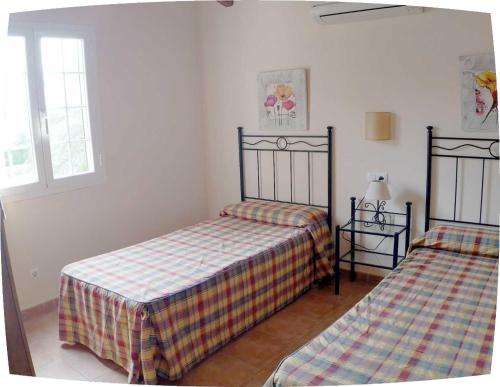 a bedroom with two beds in a room at Villa Paula in Son Carrio