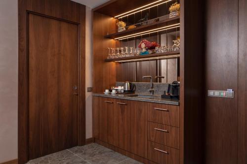 a kitchen with wooden cabinets and a sink at Lionel Hotel Istanbul in Istanbul