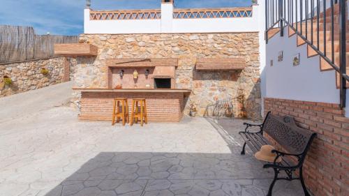 a stone building with a fireplace in a patio at Villa Naiara Torrox by Ruralidays in Torrox