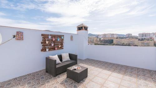 a white room with a chair and a table at Villa Naiara Torrox by Ruralidays in Torrox