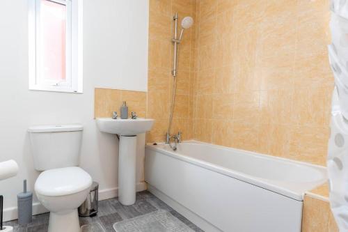 a bathroom with a toilet and a sink and a bath tub at Entire House with 3 Rooms in Liverpool