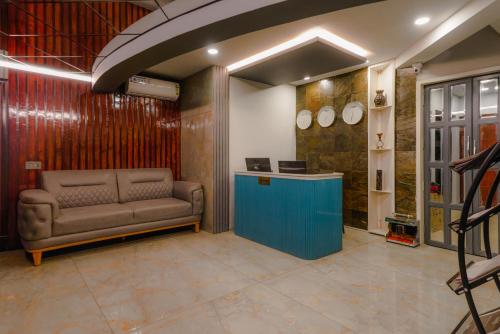 a waiting room with a couch and a counter at Dream Hotel - Richmond in Bengaluru