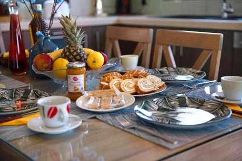 a table topped with plates of food and fruit at Zante Sunset Vibes Luxury Villa in Áno Yerakaríon
