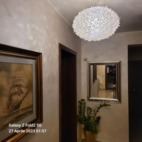 a room with two mirrors and a chandelier at Raggi di Sole in Custonaci