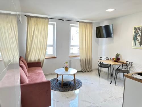 a living room with a couch and a table at MOVEEN! Wynajem apartamentów we Wrocławiu! 10 minut od centrum in Wrocław