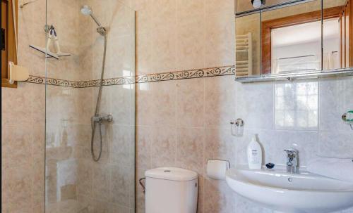 a bathroom with a shower and a toilet and a sink at Casa Eve - Beautiful Villa & Heated - Pool to Yourself in Árchez