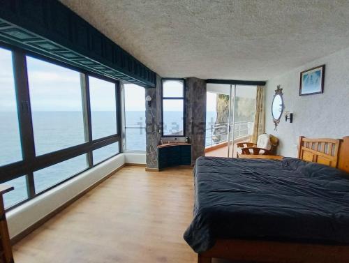 a bedroom with a bed and views of the ocean at Sea lover's nest in Los Realejos