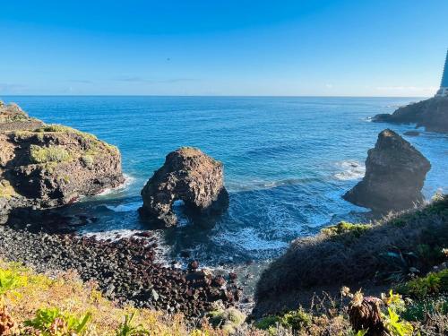 a beach with two large rocks in the water at Sea lover's nest in Los Realejos