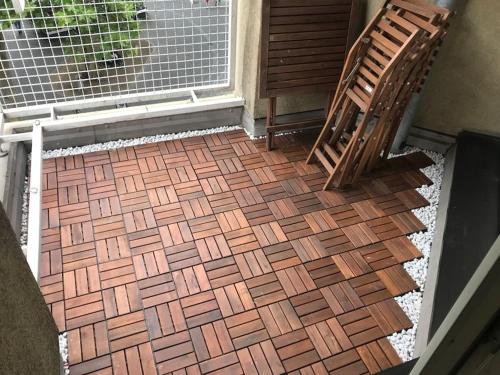 a porch with a brick floor and a wooden chair at charmantes 1Zi Apartment im Herzen von Braunschweig mit Balkon in Braunschweig