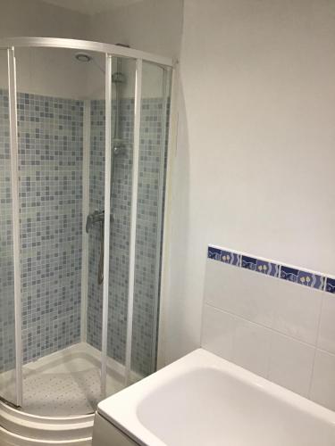 a white bathroom with a shower and a toilet at Dovedale Apartment in Moreton