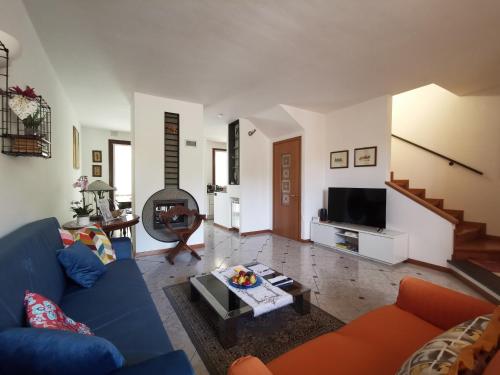 a living room with a blue couch and a tv at 7 Panorama in Montecatini Terme