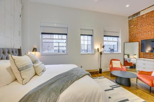a bedroom with a bed and a living room at Downtown Omaha Getaway with Deck and Gas Grill! in Omaha