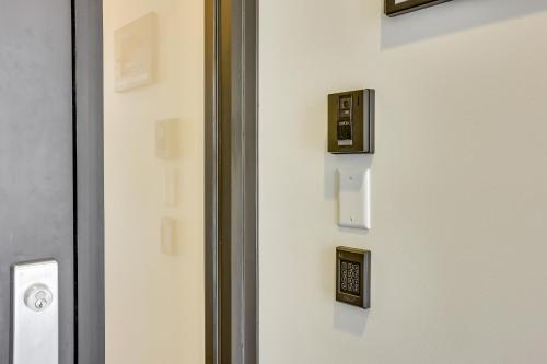a close up of a door with an electrical box on it at Downtown Omaha Getaway with Deck and Gas Grill! in Omaha