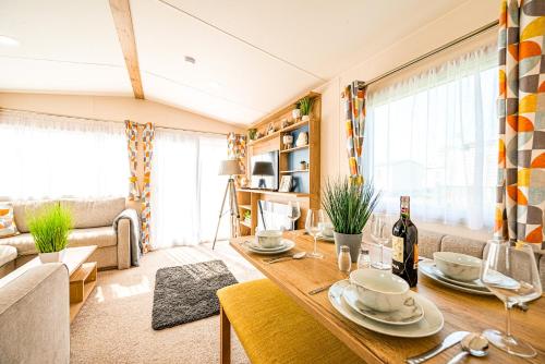 a living room with a table and a couch at The Seascape, Padstow in Padstow