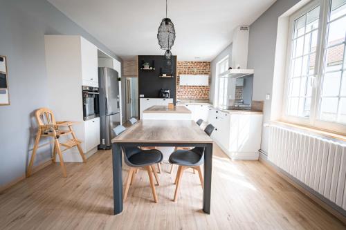 a kitchen with a table and chairs in a room at La Longère Gasiaquoise in Gauchy