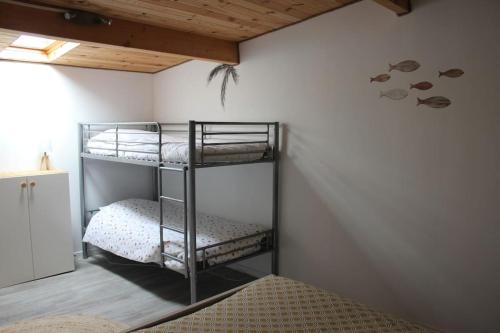 a bedroom with two bunk beds in a room at Maison Lavelanet de Comminges 