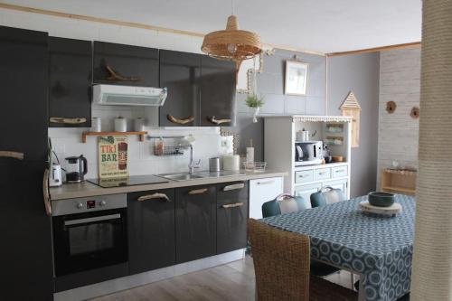 a kitchen with a table and a counter top at Maison Lavelanet de Comminges 