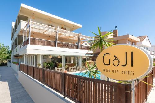 a building with a sign that reads c j lean hoteluds at GOJI Vegan Hotel in Ialysos